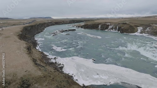 Aerial View of Thjorsa River Gorge, Iceland. Cold Glacial Water, Ice and Landscape in Early Spring, Drone Shot photo