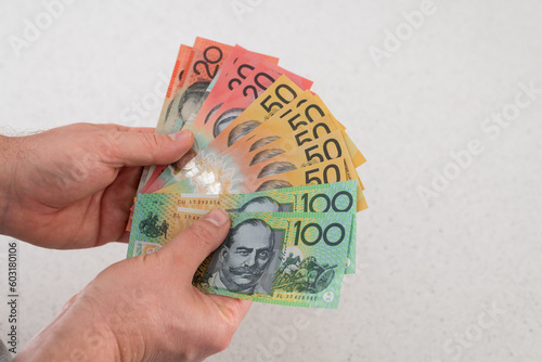 Man holding Australian money – financial