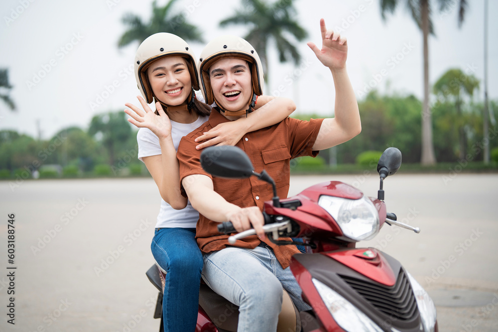 Young Asian couple on the motorbike