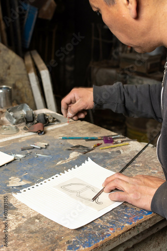 Precision and Patience: Artisan Blacksmith measuring Metal Rod for Art Piece