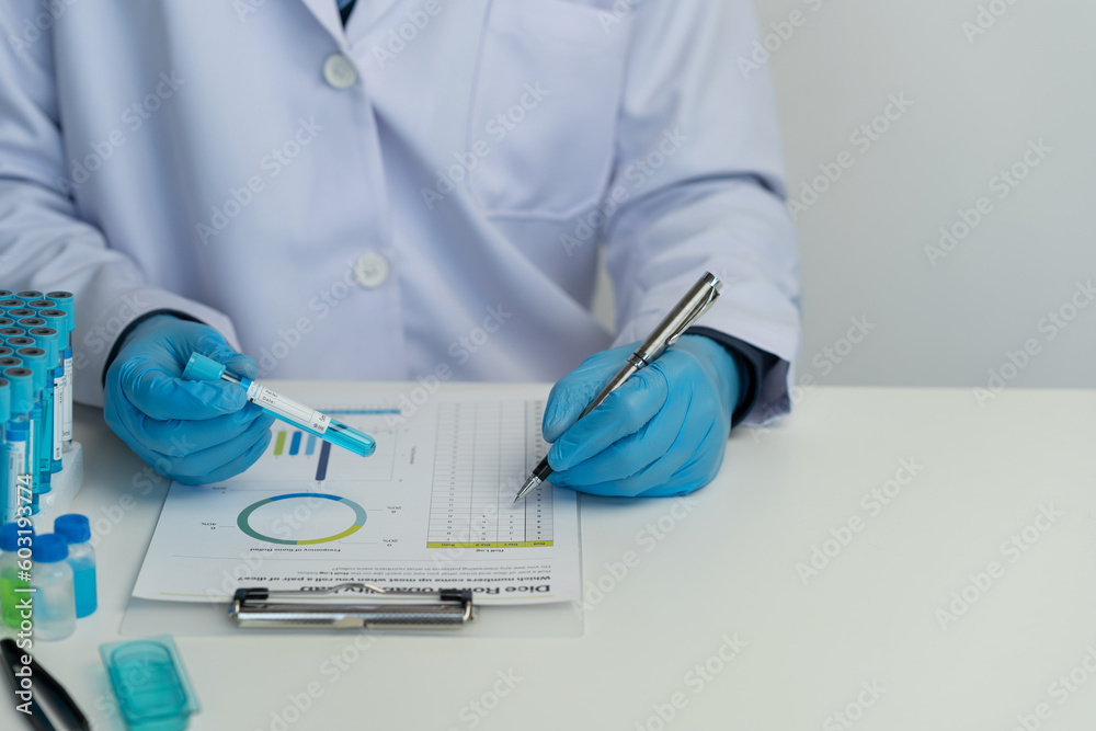 Male scientist using scientific test tubes with data recording of chemicals or drugs tested and examined by microscope in science laboratory for medicine biotechnology biology. Male scientist using scientific test tubes with data recording of chemicals or drugs tested and examined by microscope in science laboratory for medicine biotechnology biology.