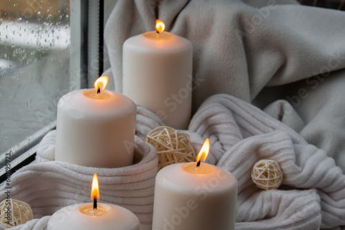 Home fragnance concept autumn holidays at cozy home on the windowsill Hygge aesthetic atmosphere on knitted white sweater. Still life of micro moment candid slow living. Mental health wellbeing