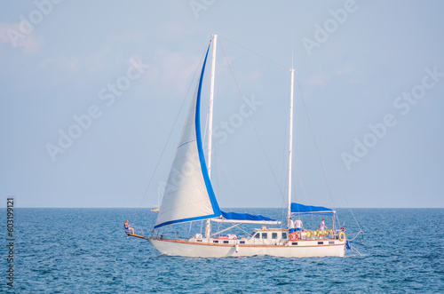 Sailing yacht in the blue calm sea.