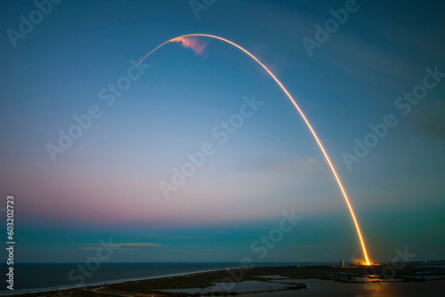 Fototapeta Beautiful rocket crossing the entire sky with its incredible trail