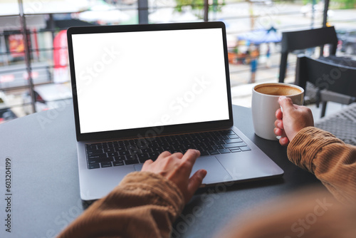 Mockup image of a woman using and working on laptop computer with blank white desktop screen