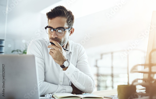 Computer, thinking and business man in office, working on project or email. Laptop, professional and male person problem solving, looking for solution or planning, reading or focus on decision making