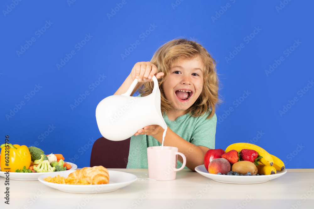 Excited child having a breakfastand pouring milk. Child drink dairy milk. Child pouring milk, studio isolated portrait. Excited child having a breakfastand pouring milk. Child drink dairy milk. Child pouring milk, studio isolated portrait.