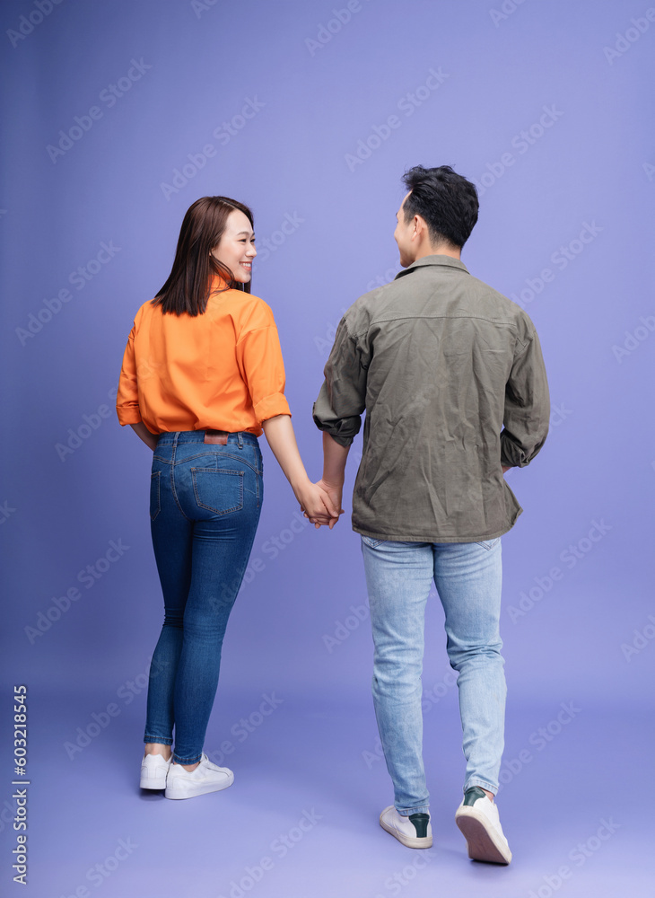 Photo of young Asian couple on background Photo of young Asian couple on background