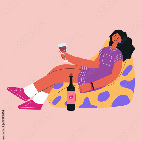 Joyful young woman sits in a chair with a glass and wine. Rest at home.
Trendy vector illustration.
