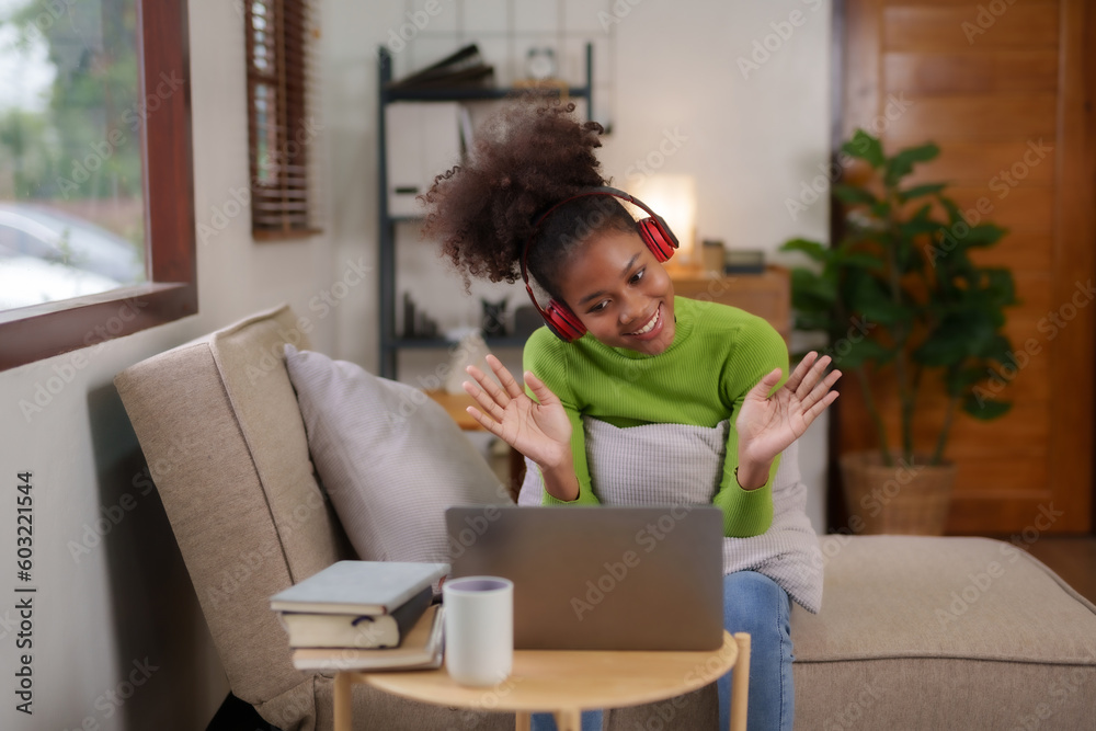 Happy young woman student having video call on laptop computer at home. Young black female chatting online in social networks, having fun. Happy young woman student having video call on laptop computer at home. Young black female chatting online in social networks, having fun.