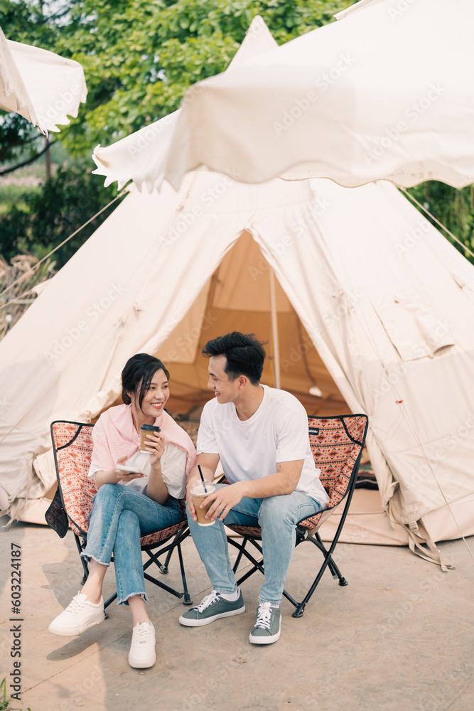 Young Asian couple camping outside