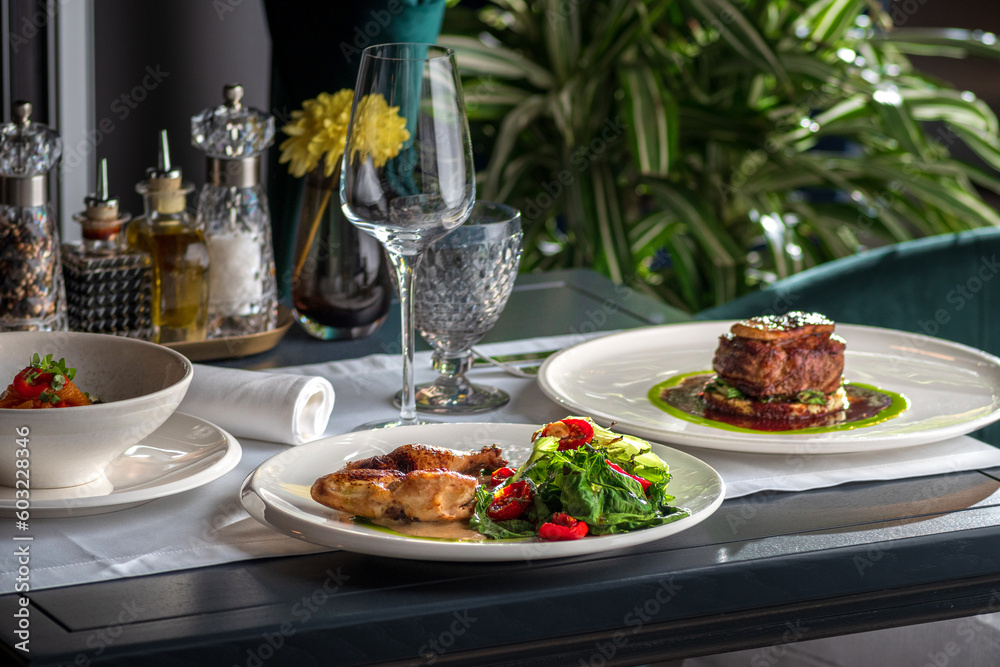 table setting with plate of beef with roasted chicken. copy space. table setting with plate of beef with roasted chicken. copy space.