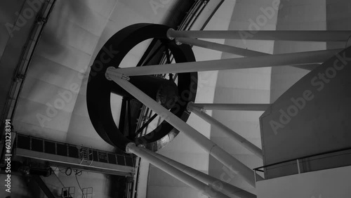 the telescope moves under the observatory dome . black-and-white shot. Observatory building from the inside. institute for space exploration. 