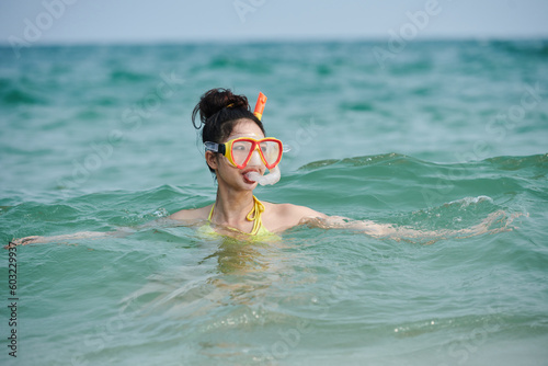 Young woman scuba diving in sea, summer vacation concept © DragonImages