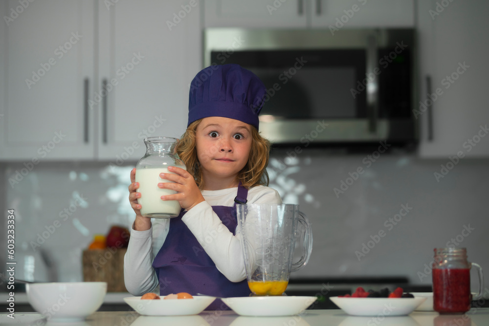 Child food preparation. Child hold bottle milk making tasty delicious. little boy in chef hat and an apron cooking in the kitchen. Child food preparation. Child hold bottle milk making tasty delicious. little boy in chef hat and an apron cooking in the kitchen.