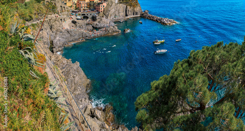 Mediterranean Sea with boats and cliffs above from Manarola, Cinque Terre, Italy