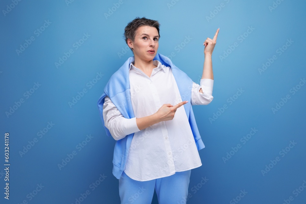 energetic fashionable dark-haired woman in a cool look with a genius proposal points her finger energetic fashionable dark-haired woman in a cool look with a genius proposal points her finger
