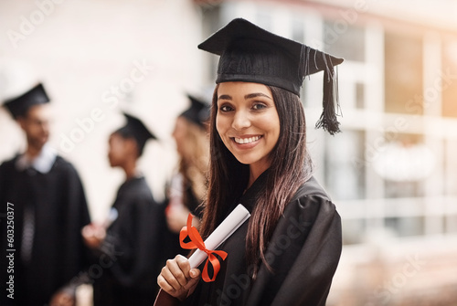 Graduation, diploma and portrait of a woman or college student with happiness and pride outdoor. Female person excited to celebrate university achievement, education success and school graduate event photo