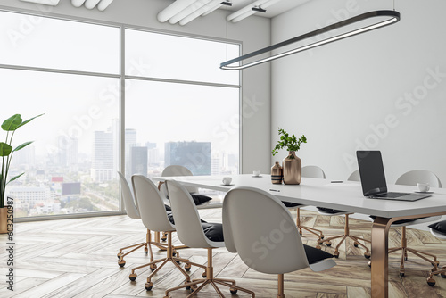 Fototapeta Naklejka Na Ścianę i Meble -  Perspective view on stylish white meeting table with golden legs and wheel chairs around on wooden floor and white wall background in sunlit conference area with city view backdrop. 3D rendering