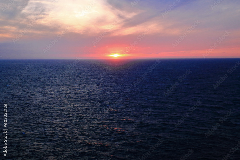 Sunset in Cape Saint Vincent with the sun going down the horizon over the water Sunset in Cape Saint Vincent with the sun going down the horizon over the water