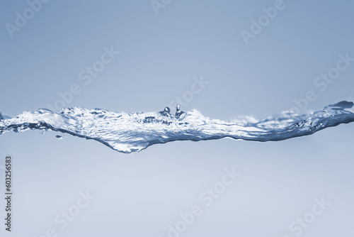 Water splash Aqua flowing in waves and creating bubbles Drops on the water surface feel fresh and clean isolated on white background. 