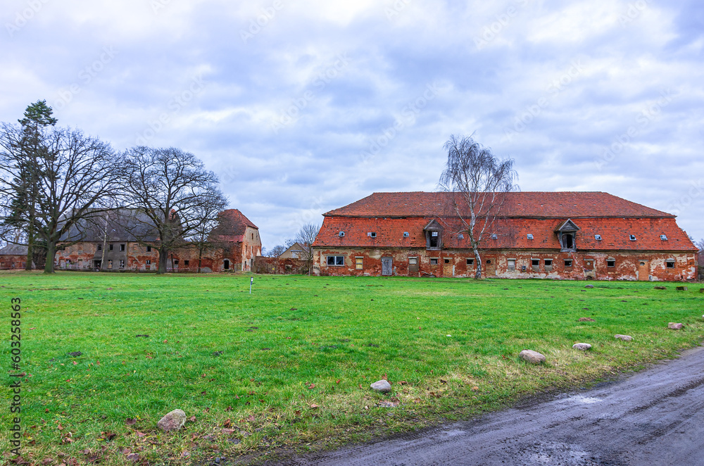 Dilipidated outbuilding and barns of a disintegrated baroque manor, Kummerow Manor, Mecklenburg Pomerania, Germany. Dilipidated outbuilding and barns of a disintegrated baroque manor, Kummerow Manor, Mecklenburg Pomerania, Germany.