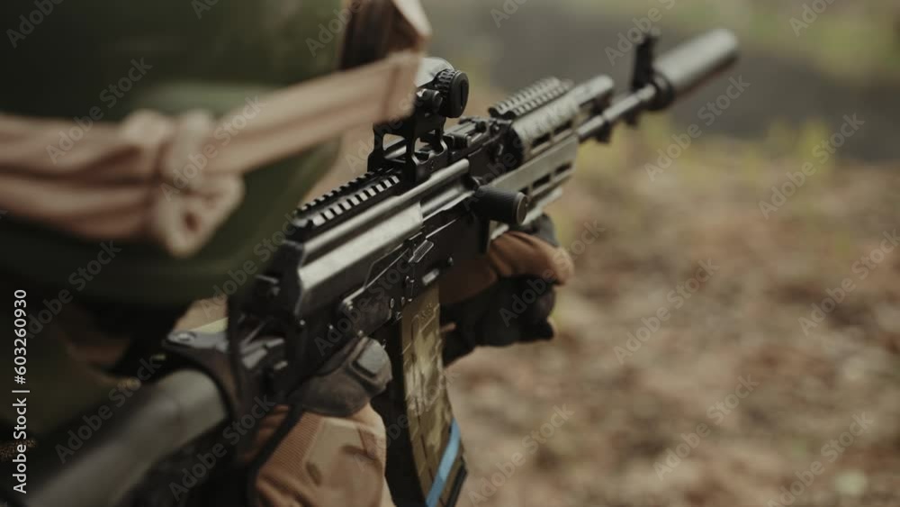 A soldier shoots at the enemy with a sniper rifle A soldier shoots at the enemy with a sniper rifle