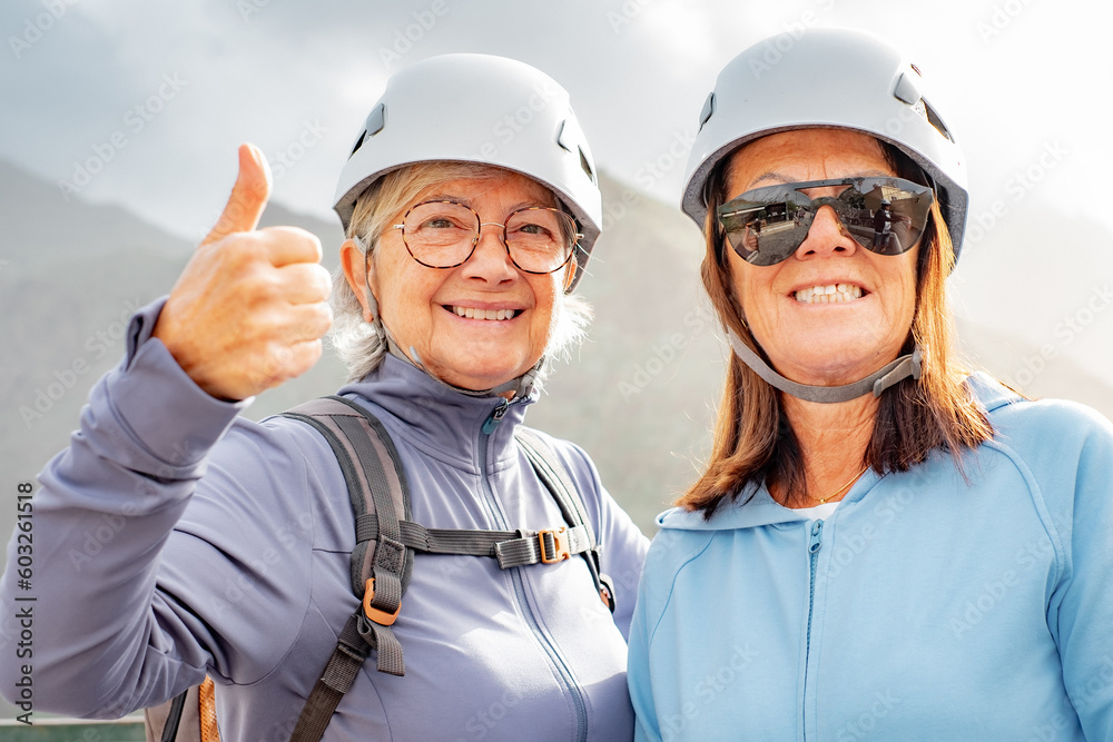 Smiling senior women hikers walking on mountain enjoying a trekking day - Carefree climbing tourists enjoying holidays and healthy lifestyle - Freedom, health, sport concept Smiling senior women hikers walking on mountain enjoying a trekking day - Carefree climbing tourists enjoying holidays and healthy lifestyle - Freedom, health, sport concept