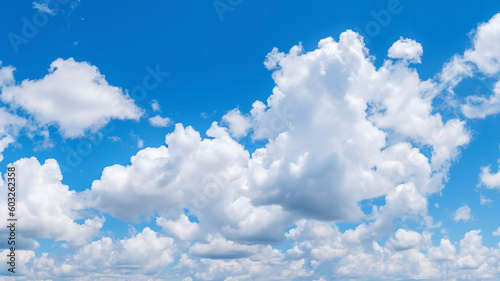 Blue sky filled with fluffy white clouds.