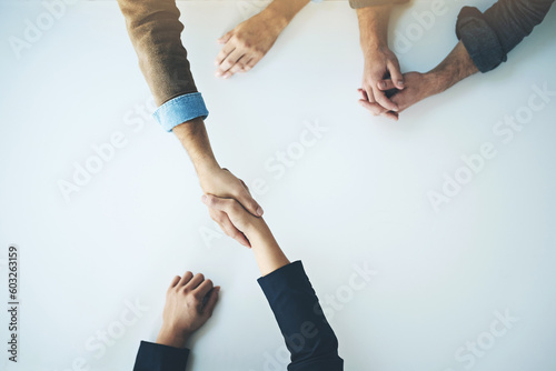 Handshake, agreement and business people in partnership, support and trust together for business consulting. Above, collaboration and team in negotiation, welcome or deal with witness at table