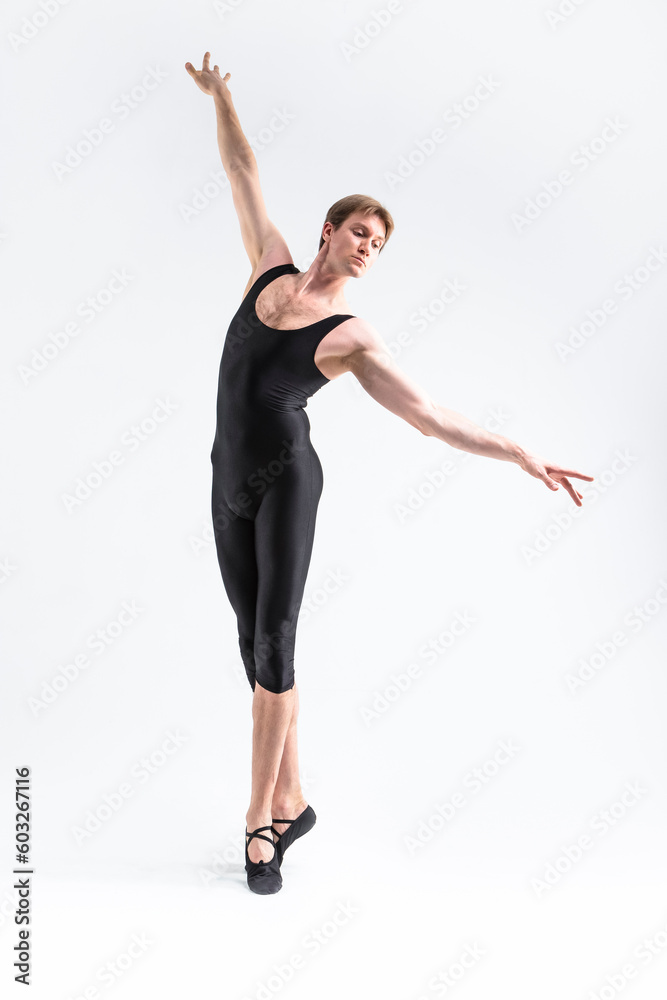 Contemporary Ballet Dancer Flexible Athletic Man Posing in Black Tights in Ballanced Dance Pose With Hands Outstretched in Line