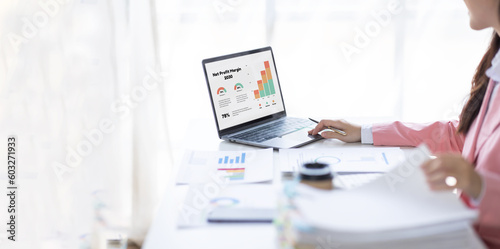 Financial Businesswomen analyze the graph of the company's performance to create profits and growth, Market research reports and income statistics, Financial and Accounting concept. 