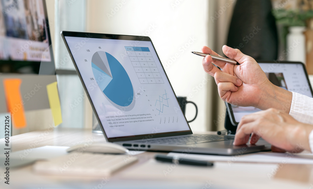 Obraz premium Businessman using laptop computer analyze business growth graph and Marketing strategy planning