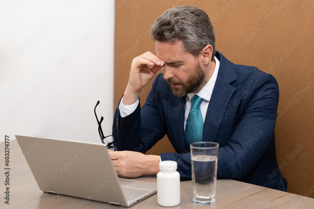 Headache and eye strain on laptop. Business man with stress and fatigue eyestrain. Businessman rubbing tired eyes after computer work. Vision problem, bad sight feeling eyestrain fatigue pain. Headache and eye strain on laptop. Business man with stress and fatigue eyestrain. Businessman rubbing tired eyes after computer work. Vision problem, bad sight feeling eyestrain fatigue pain.