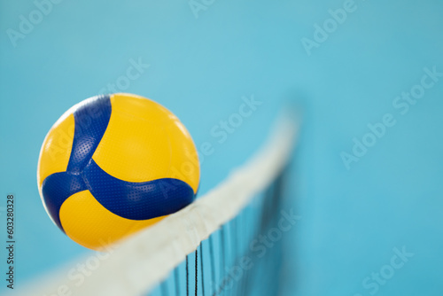 Blurred photo in action of a volleyball near the net. Playing volleyball, ball reaching opponents side of the net photo