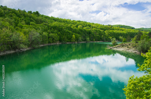 View of the reflection of the clouds on mountain lake in the Marche region Italy