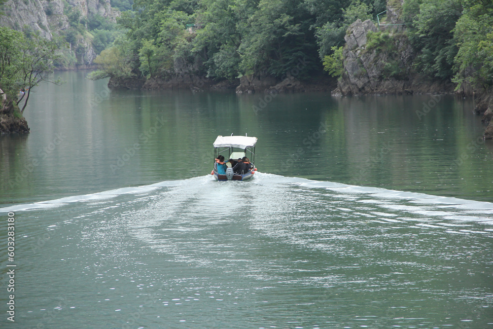 Fototapeta premium A boat taking tourists in the matcha canyon in Macedonia. Selective focus on the boat.