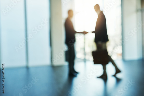 Handshake, silhouette and blur of business people in office for partnership, collaboration and agreement. Corporate, recruitment and and blurred men shaking hands for thank you, welcome and deal