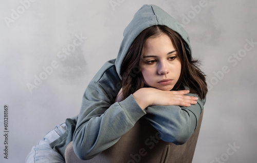 Teenage girl in depression, lonely, thinks about problems and is sad. The concept of adolescent psychology. Psychological problems. photo