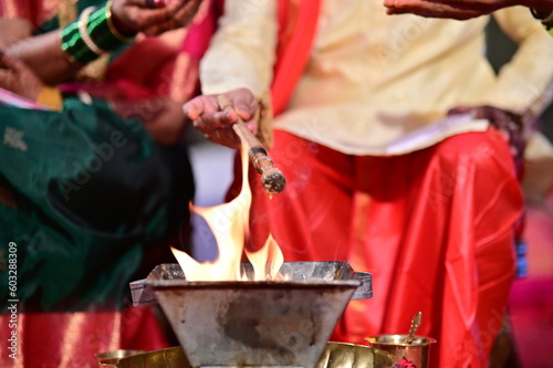 fire worship in marathi wedding. Drops in holy fire for blessing in wedding. Bride and Groom Fire Wedding Worship Rituals and Ceremony. Maharashtra 