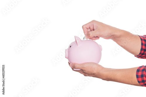 Man holding pink piggy bank and put coins in piggy bank.