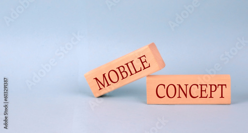 MOBILE CONCEPT text on the wooden block, blue background