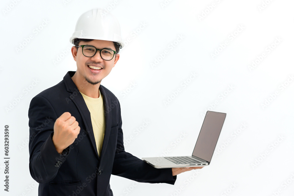 Asian young male architect or engineer construction Smiling looking at the camera holding a laptop making a happy gesture isolated on white background Copy space over a white studio background. Asian young male architect or engineer construction Smiling looking at the camera holding a laptop making a happy gesture isolated on white background Copy space over a white studio background.