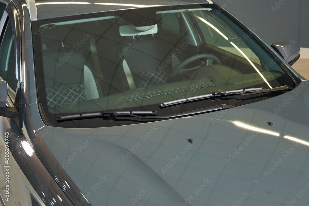 Fototapeta premium clean transparent windshield of a gray car. windshield wipers, front panel, steering wheel, seats are visible