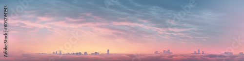 extreme wide angle of a multi colored sky and skyline at dawn in soft  muted pastel colors pink and blue