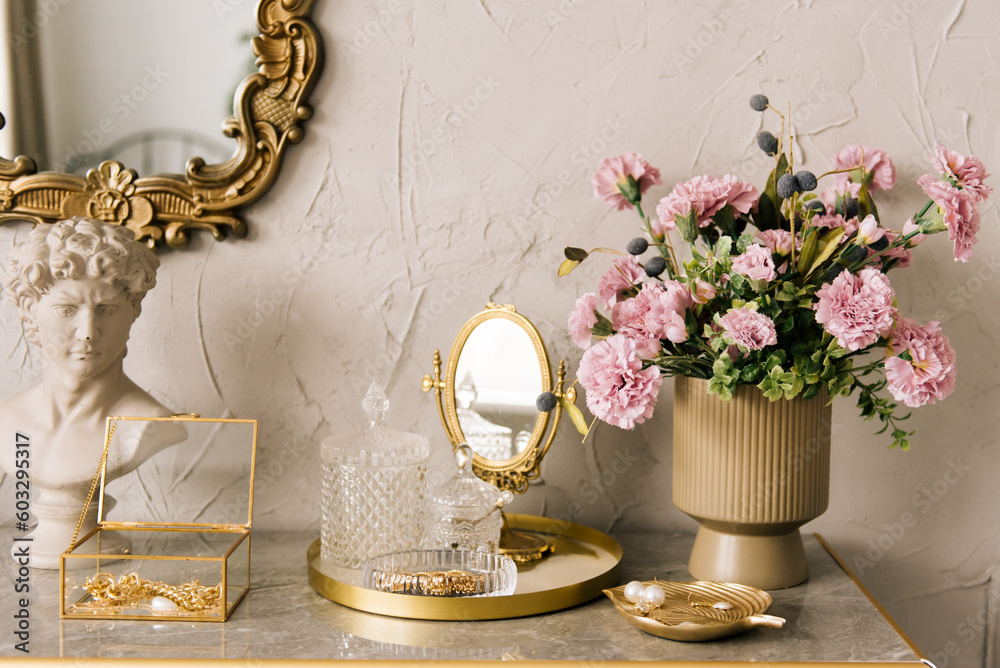 Details of the luxurious interior of a women's dressing table with flowers and decorations