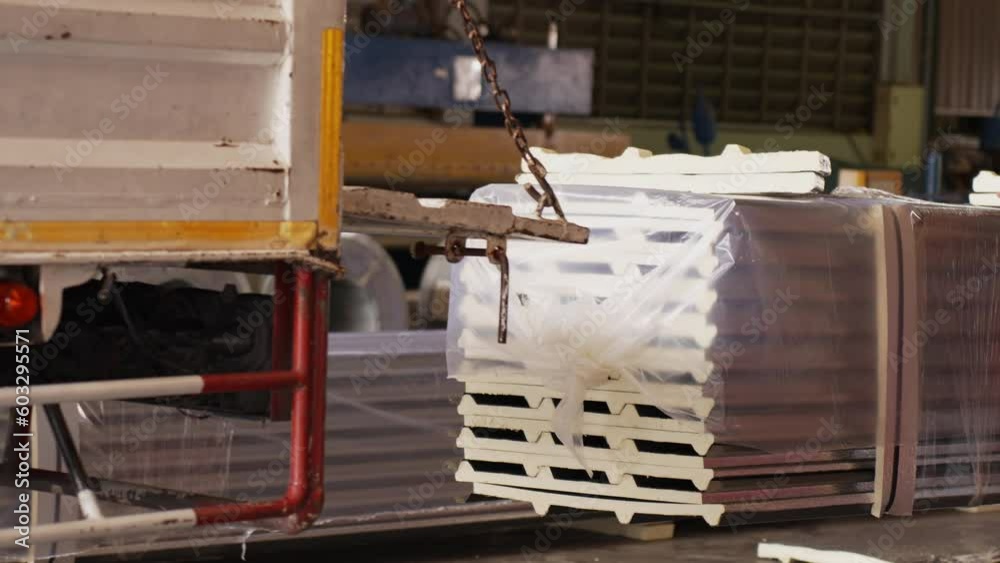 Metalsheet factory with lifting crane move metal sheet matherial to inventory warehouse for shipping.