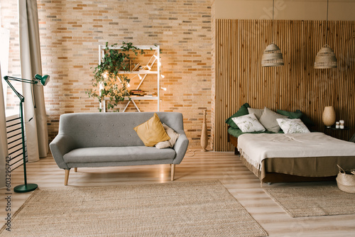 Obraz na płótnie Modern boho bedroom interior with wooden slats, wicker lamps, emerald textiles w salonie