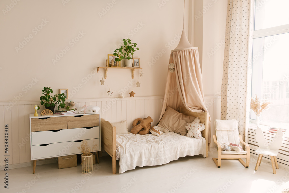 Beautiful stylish children's room, the crib is decorated with a canopy and pillows