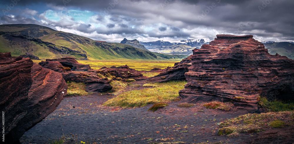 Amazing Iceland nature landscape. Scenic Image of Iceland. red sandy Volcanic rock formation near Dyrholaey coast of Iceland, Europe. Typical Icelandic scenery in sunset